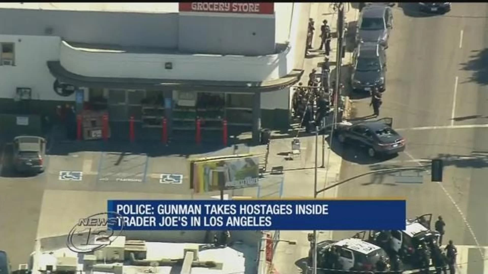 Shooting suspect in standoff at LA market; 1 woman killed